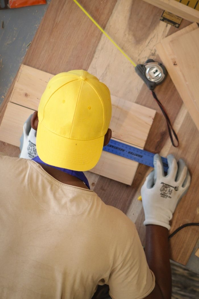 Crafting Captivating Headlines: Your awesome post title goes here A man working with precision measuring wood in Blantyre, Malawi for carpentry.